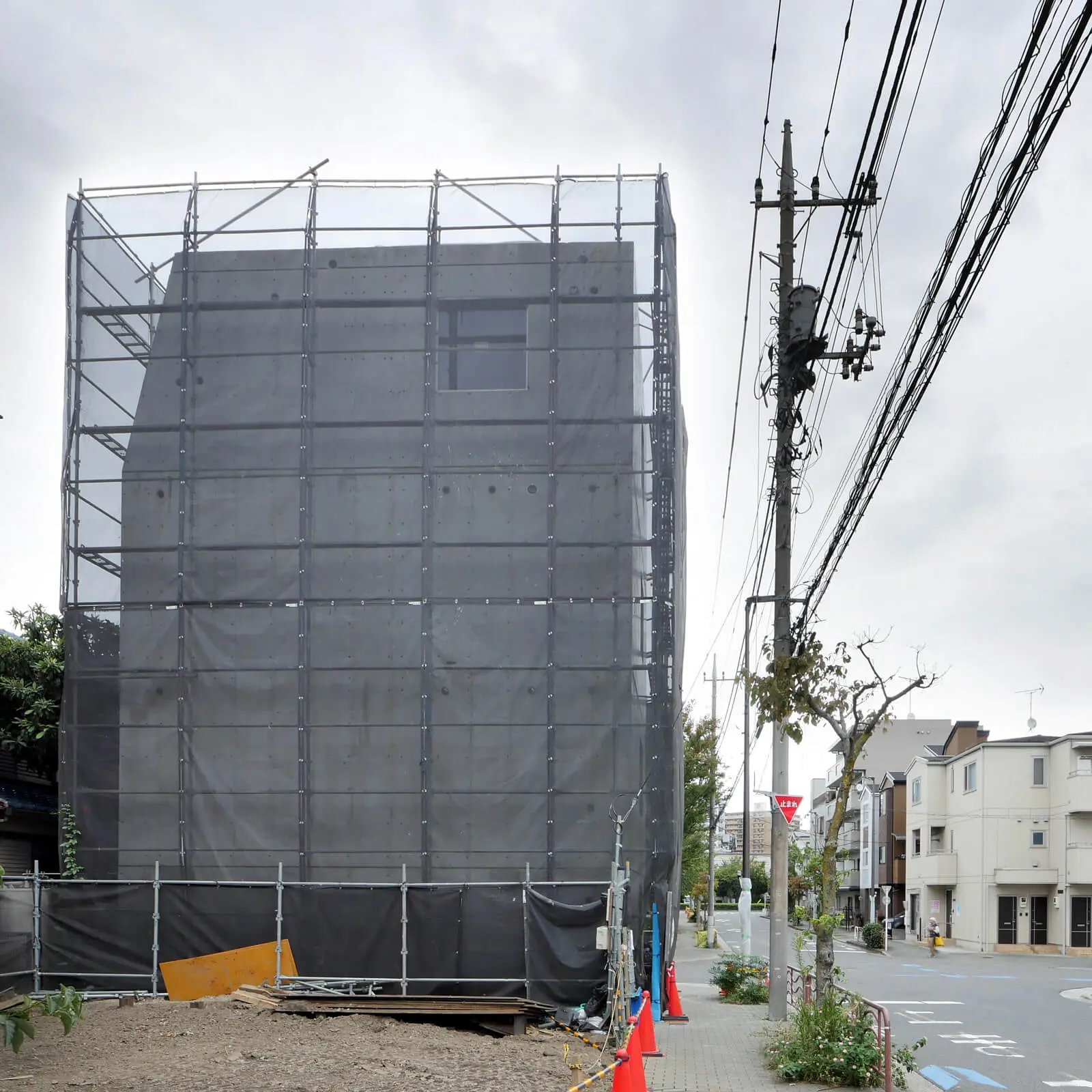西側外観。4階の1400mm角の窓にサッシとガラスが取り付けられた状況(江東区潮見 RC造オフィスビル)